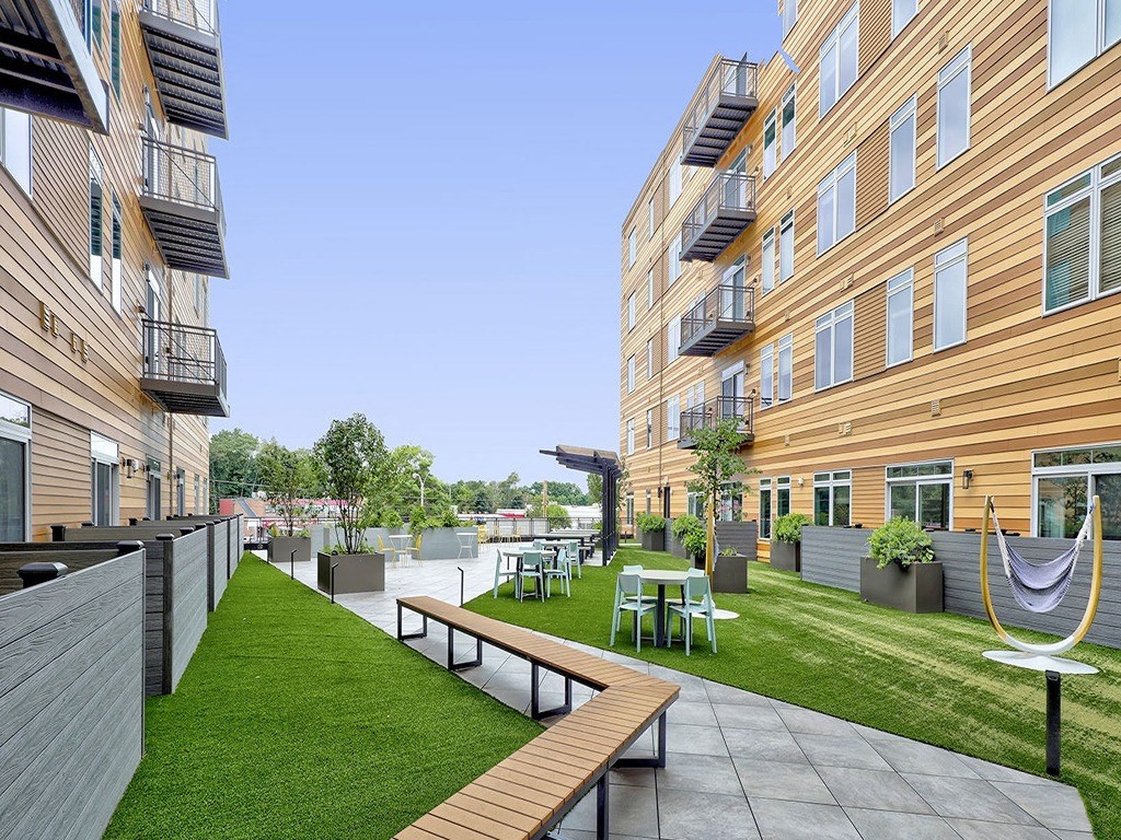 a rendering of a patio area in a building with grass